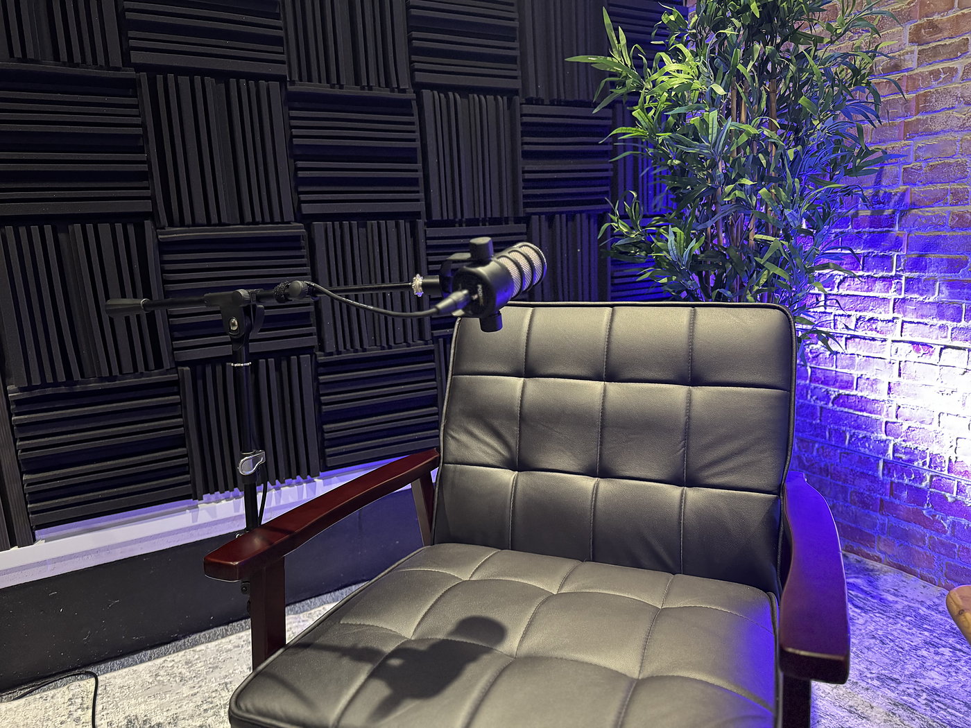 Acoustic panels, chair and microphone in a fitted studio corner