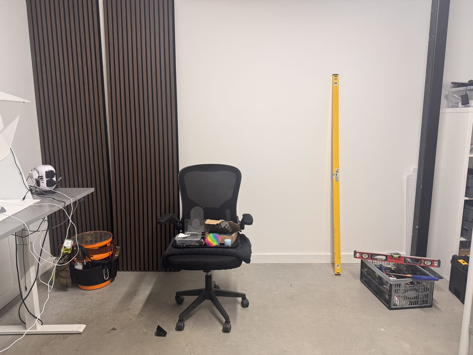 The empty room before the Vox Live build: bare walls, one chair and a spirit level