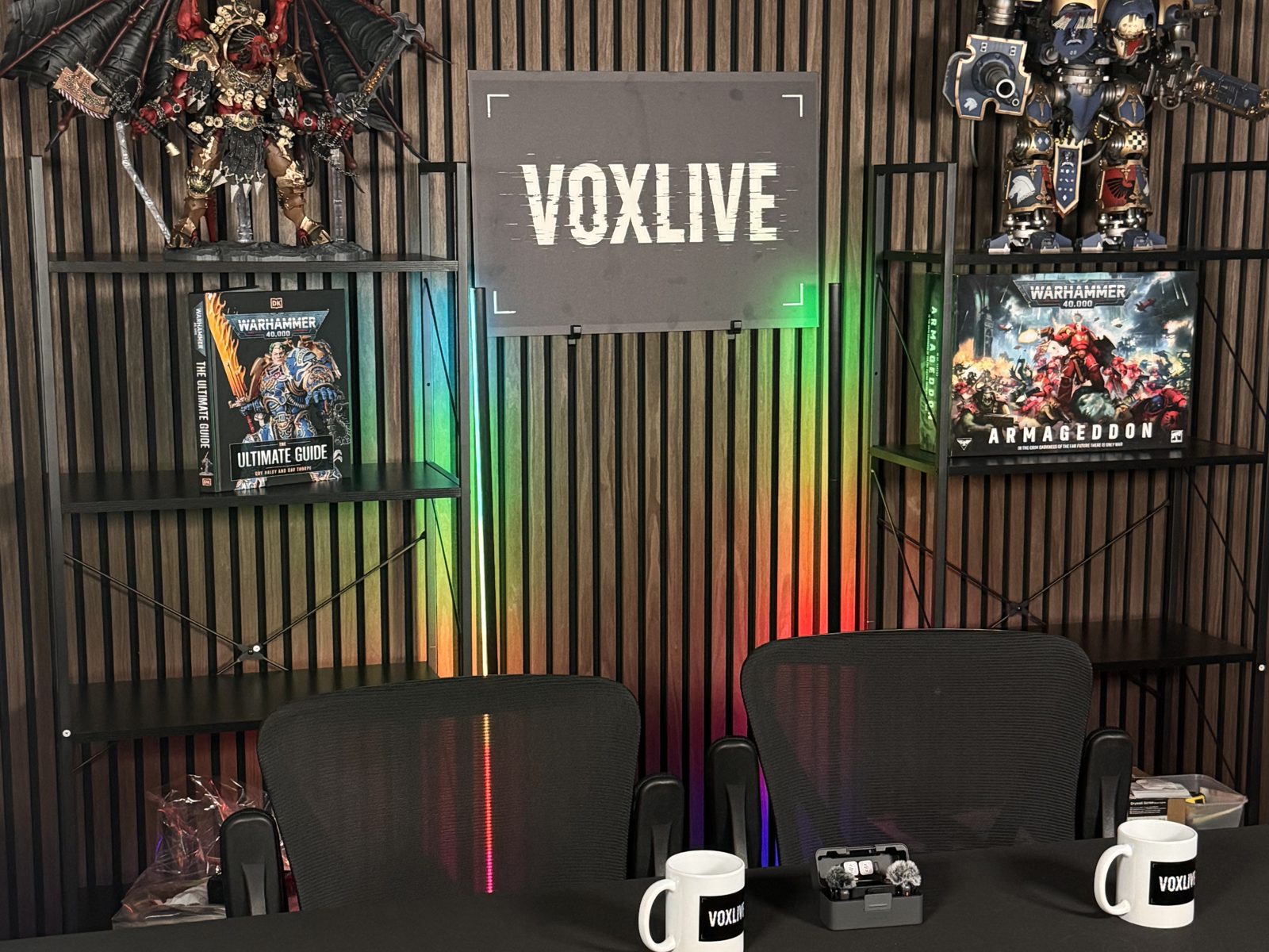 The finished Vox Live set with wood slat wall, LED colour wash and branded backdrop