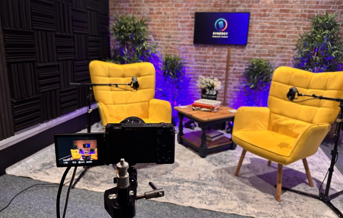 Looking past a camera onto the yellow chairs set